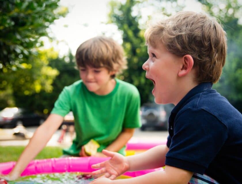 Two boys play outside at a child care center.